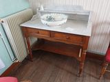 une salle de bains équipée d'un lavabo et d'une chaise