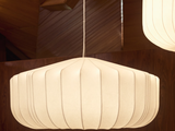 two white lamps hanging from the ceiling in a room