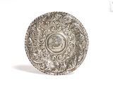 a silver plate with a picture on it on a white background