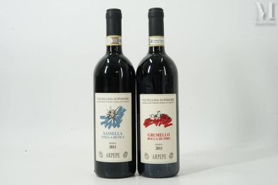 two bottles of red wine sitting next to each other on a table