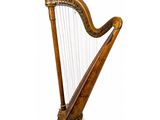 a large wooden harp sitting on top of a white surface