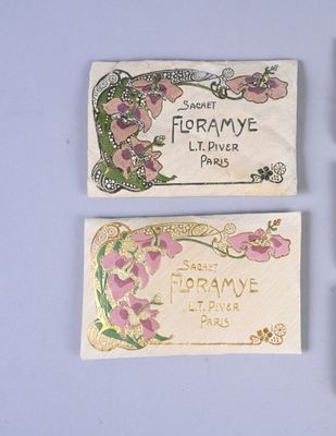 three different types of perfume labels on a white surface