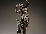 bronze statue of a woman with a dog and a clock