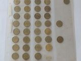 a lot of coins in a plastic bag on a table