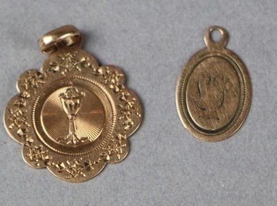 two gold medals with a picture of a woman on them