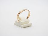 a close up of a gold ring on a white surface