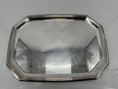 un plateau en argent sur lequel se trouve un miroir, posé sur une table