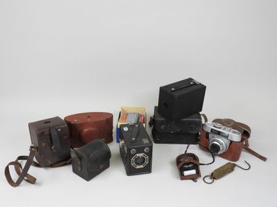 a lot of old cameras and other items on the table