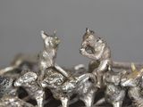 a lot of silver figurines that are on a table