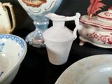 many different types of dishes and bowls on the table