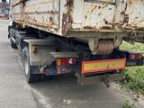 a dump truck that is parked on the side of the road