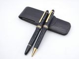 pair of black and gold fountain pens and case on a white surface