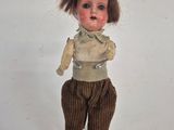 a close up of a doll on a white surface