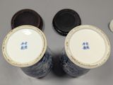 two blue and white vases sitting next to each other on a table