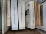 several books are stacked on top of each other on a shelf