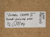 a label on a piece of cardboard that says zombie creed