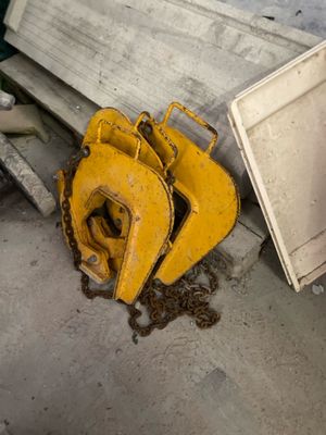a yellow bulldozer sitting next to a pile of junk