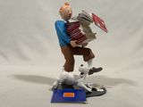 figurine of a man with an accordion and a dog on a table