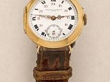 a close up of a wrist watch with roman numerals on it