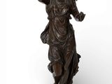 bronze statue of a woman holding a flower in her hand