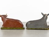 pair of ceramic bull figurines in the shape of a bull and a bull