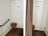 a bathroom with a shower, toilet, and a bench in it