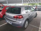 a silver car parked in a parking lot next to a red car