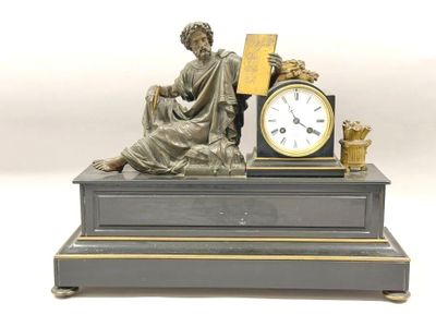 a statue of a woman sitting on top of a table with a clock