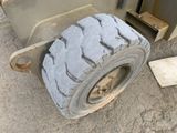 a tire that is sitting on the ground next to a machine