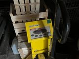 a yellow machine that is sitting next to a pile of boxes