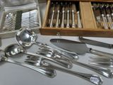 a lot of silverware sitting on a table next to a wooden box