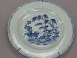 three plates with blue and white designs on them on a table