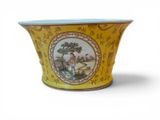 a yellow vase with a picture of a man and a dog on it