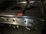 a large metal stove in the middle of a kitchen