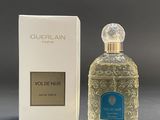 an image of a bottle of perfume next to a box of perfume