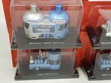three toy cars in a display case on a table