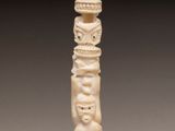 a carved ivory figurine of a man and woman