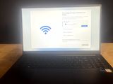 a laptop that is sitting on a table with a wifi sign on the screen