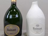a bottle of wine next to a bottle of wine on a table