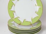 four plates stacked on top of each other on a white surface