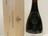 a bottle of wine sitting next to a wooden box