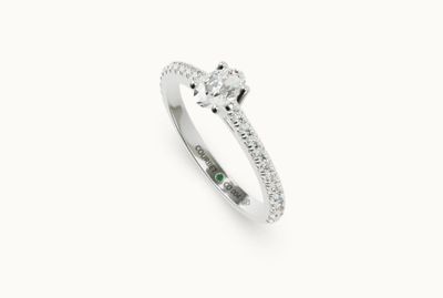 a close up of a diamond ring on a white background