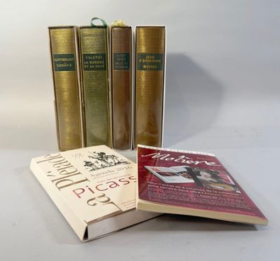 three books sitting on top of a white table next to each other