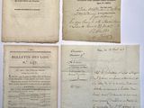 three old papers with handwriting on them sitting on top of a table