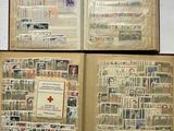 three open books with stamps on them sitting on top of a table