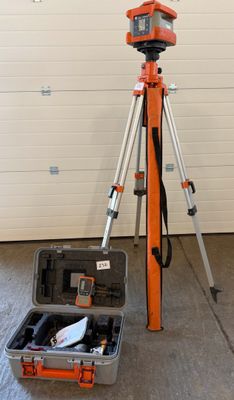 a tripod and a camera in a case in a garage