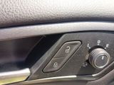 a close up of a car ' s door handle and control panel