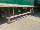 a large green semi truck parked in a parking lot