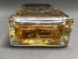 a small bottle of perfume sitting on a table