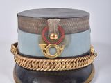 a hat with a chain around it on a white surface